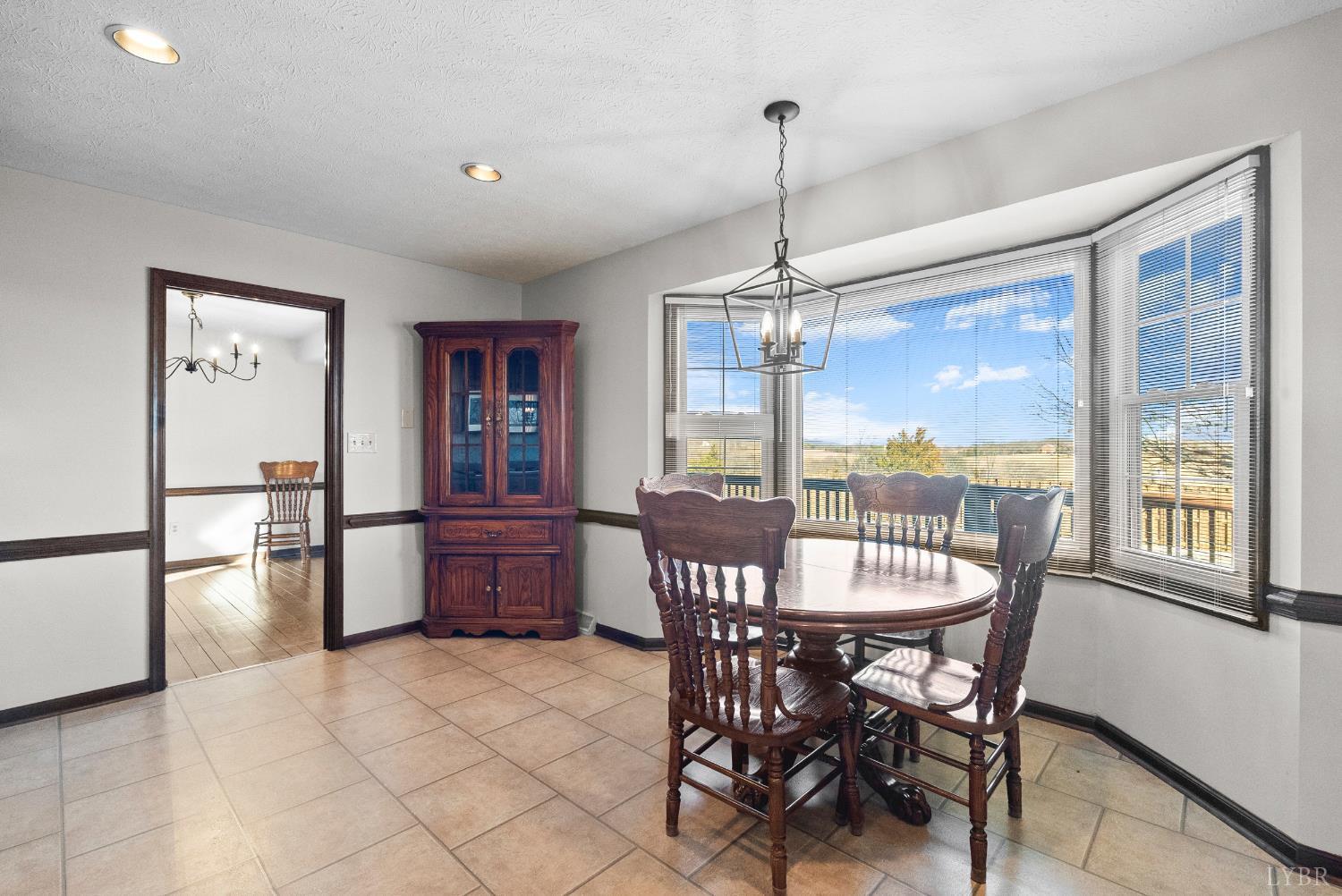 1159 Cifax Road Forest, VA 24551 - Photo 14 of 60 a dining room with furniture a chandelier and wooden floor