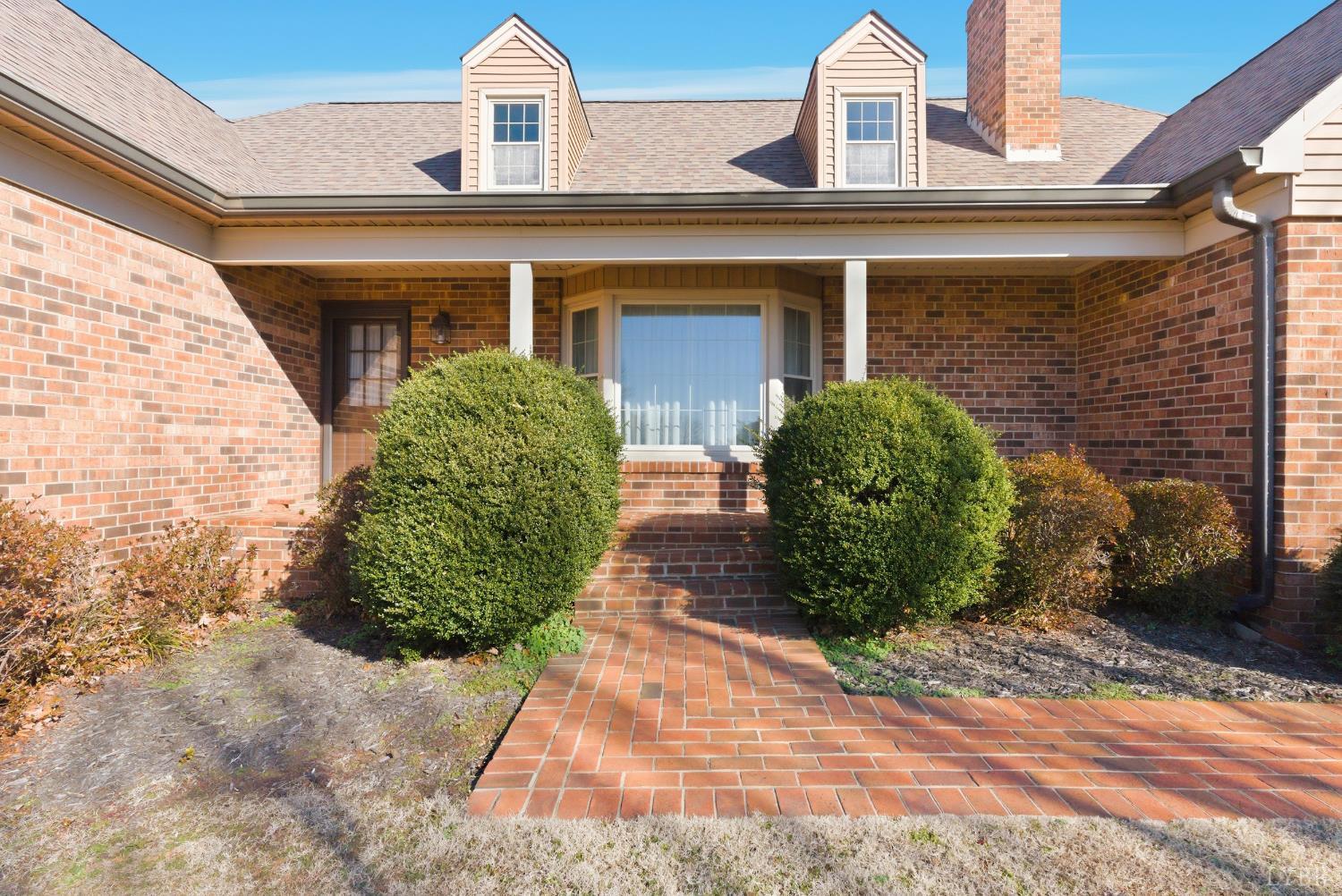 1159 Cifax Road Forest, VA 24551 - Photo 2 of 60 a view of a brick house with potted plants