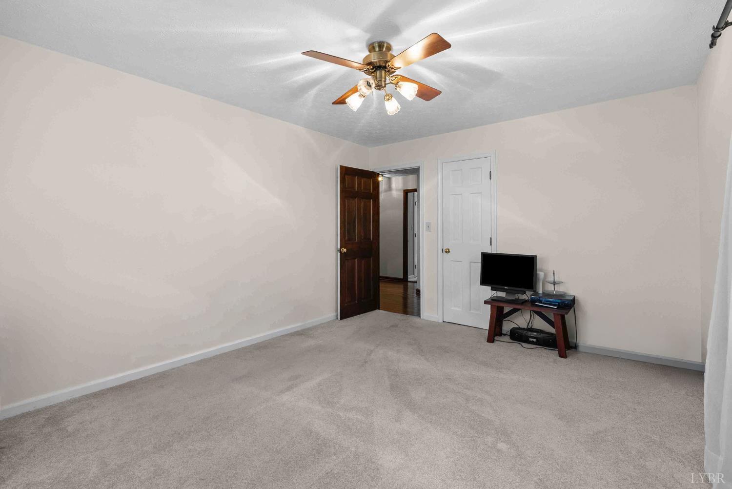 1159 Cifax Road Forest, VA 24551 - Photo 27 of 60 a view of a livingroom with a flat screen tv and a ceiling fan
