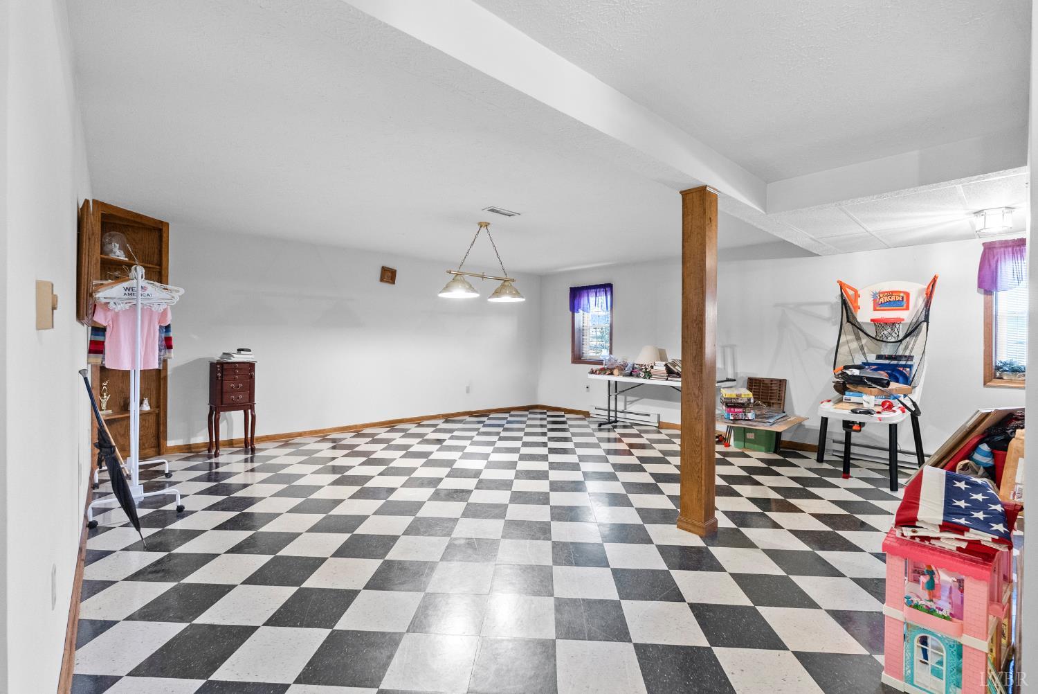 1159 Cifax Road Forest, VA 24551 - Photo 38 of 60 a living room with a black white checkered floor with a gaming machine and dining chairs