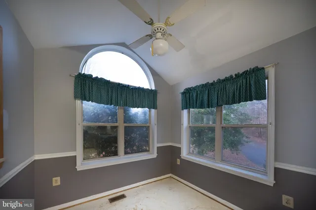 a view of a room with a large window and a fireplace