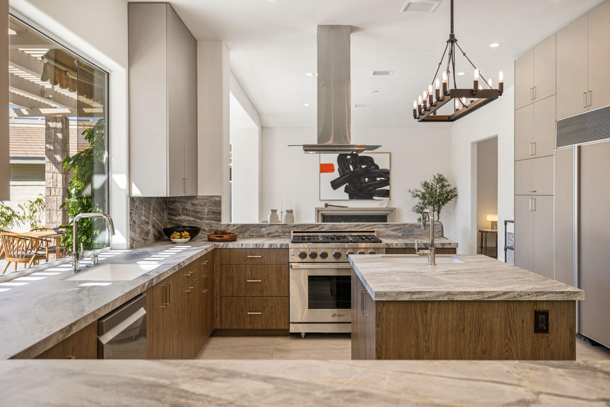 9 Regency Drive Rancho Mirage, CA 92270 - Photo 18 of 86 a kitchen with stainless steel appliances granite countertop a stove a sink dishwasher and a refrigerator with wooden floor