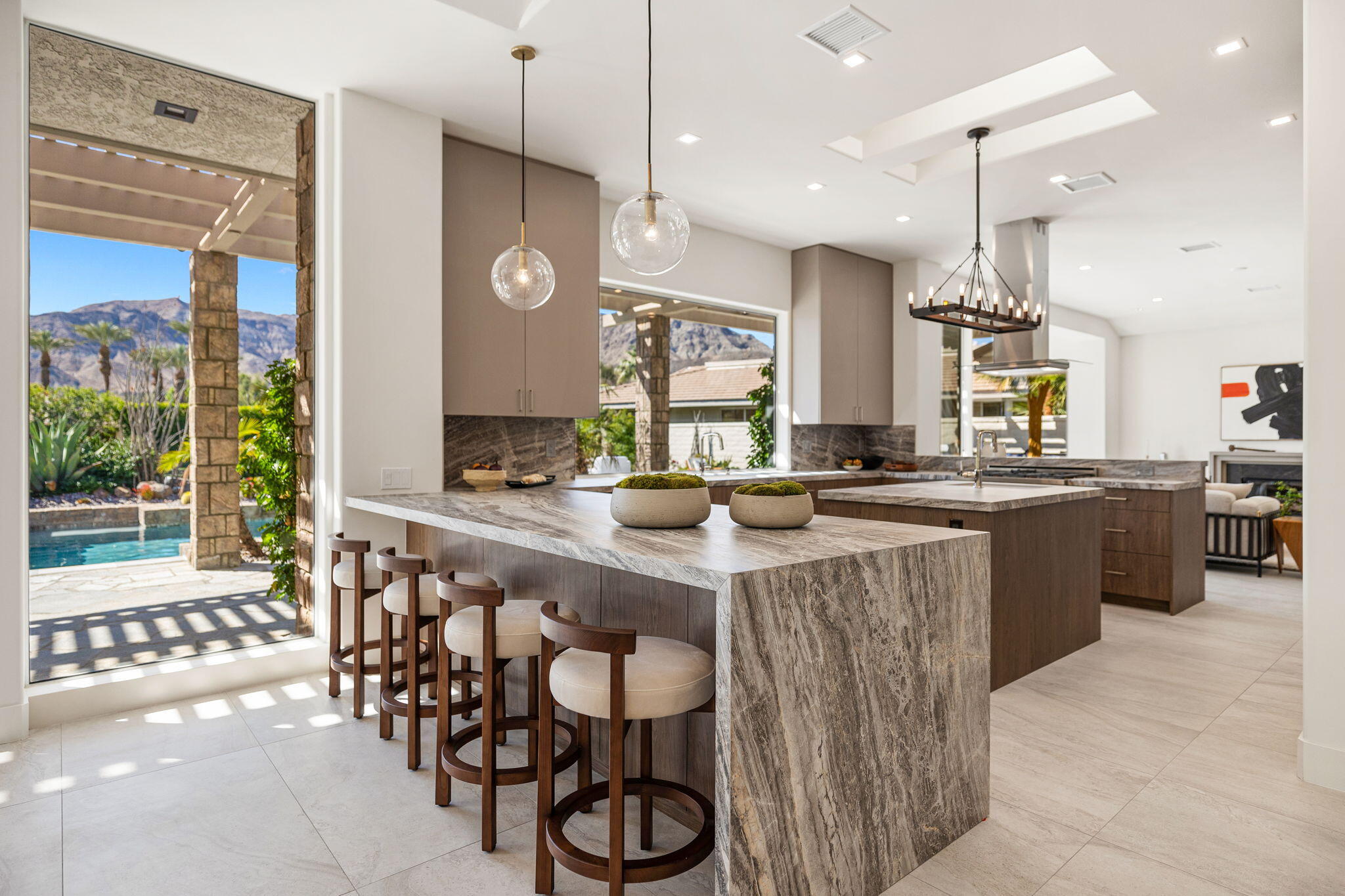 9 Regency Drive Rancho Mirage, CA 92270 - Photo 22 of 86 a kitchen with a sink and chairs