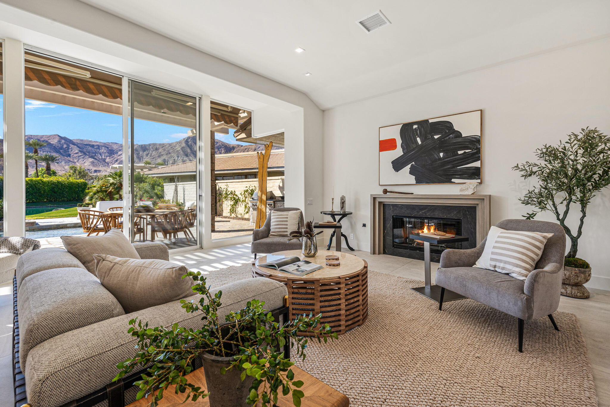 9 Regency Drive Rancho Mirage, CA 92270 - Photo 30 of 86 a living room with furniture fireplace and a large window