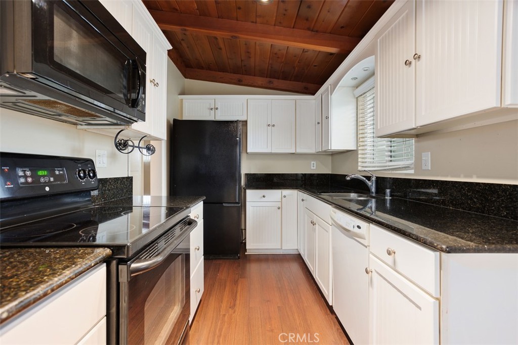 1710 Valley Place Carlsbad, CA 92008 - Photo 11 of 31 a kitchen with stainless steel appliances granite countertop a sink a stove and a refrigerator