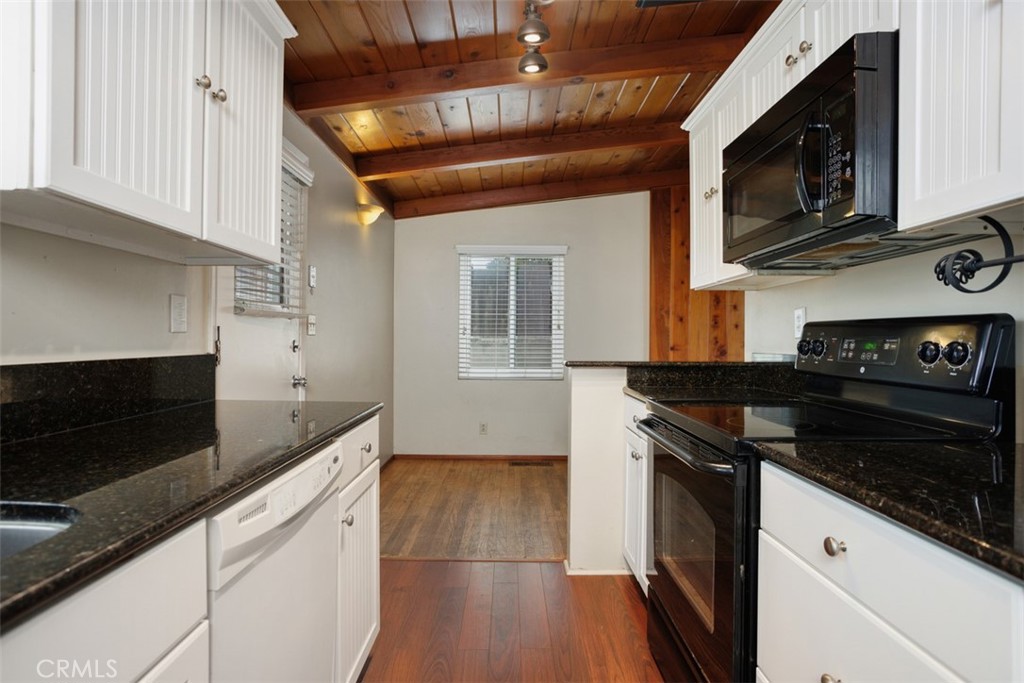 1710 Valley Place Carlsbad, CA 92008 - Photo 14 of 31 a kitchen with stainless steel appliances granite countertop a stove microwave and sink