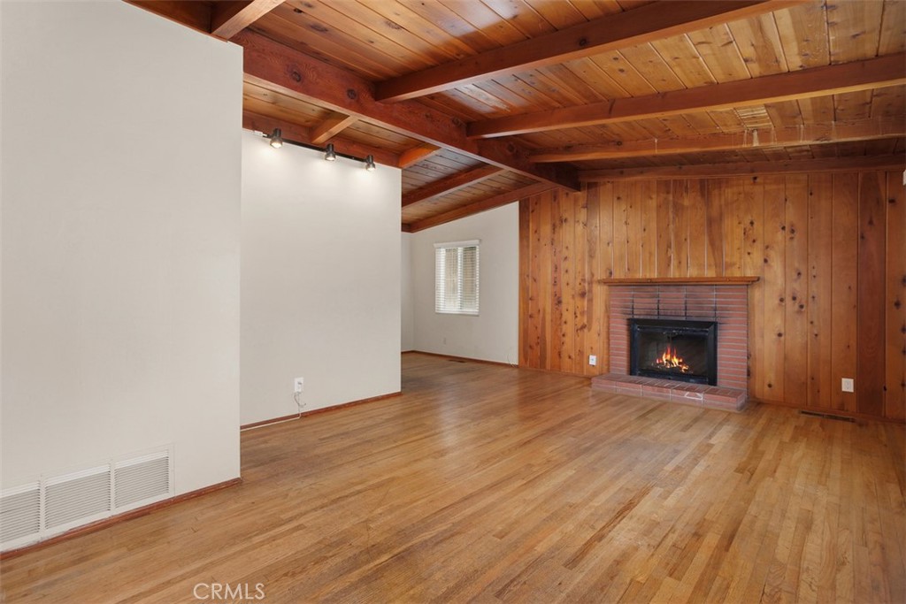 1710 Valley Place Carlsbad, CA 92008 - Photo 2 of 31 a view of an empty room with wooden floor fireplace and a window