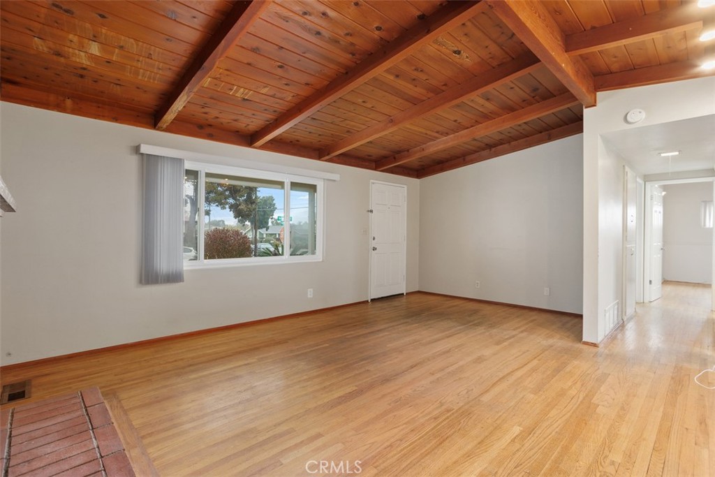 1710 Valley Place Carlsbad, CA 92008 - Photo 4 of 31 a view of an empty room with wooden floor and a window