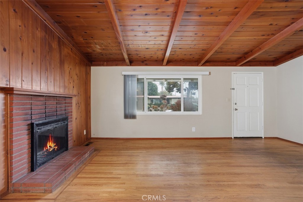 1710 Valley Place Carlsbad, CA 92008 - Photo 6 of 31 a view of an empty room with wooden floor and a fireplace