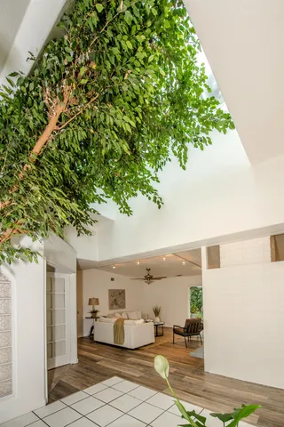 a living room with furniture and a chandelier
