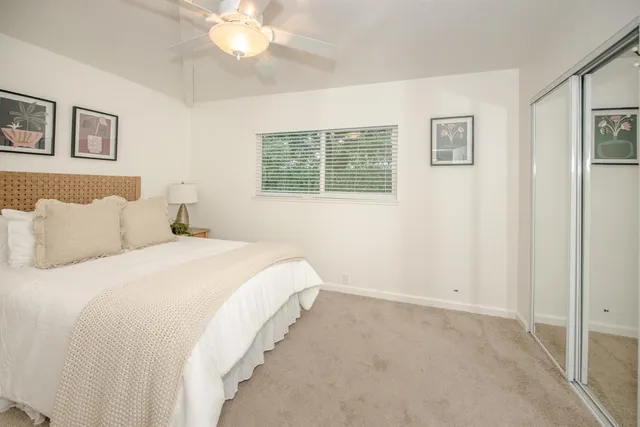 a view of a patio with a table and chairs next to a yard
