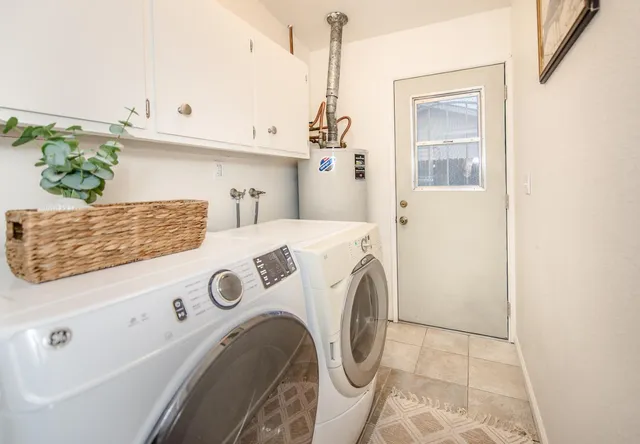 a view of a house with a garage and potted plants