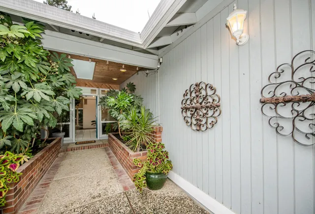 a living room with furniture a chandelier and a rug