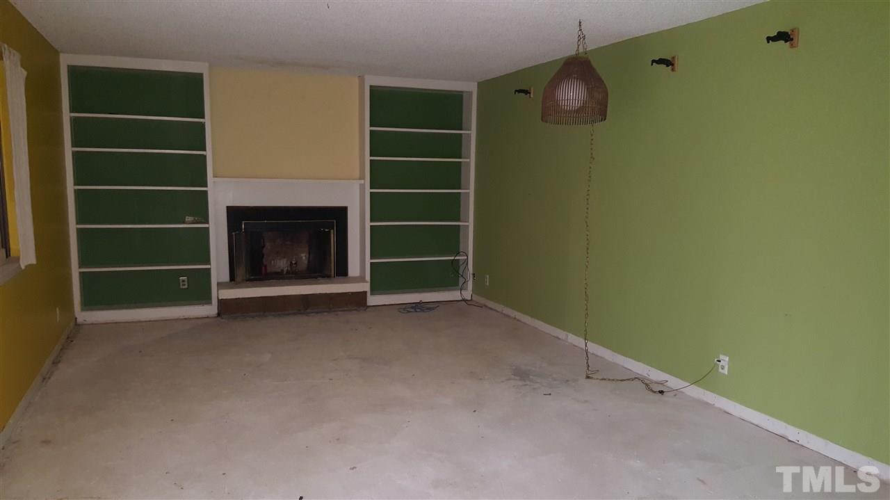 3088 Colony Road, Unit D Durham, NC 27705 - Photo 4 of 11 a view of an empty room with a fireplace and a window