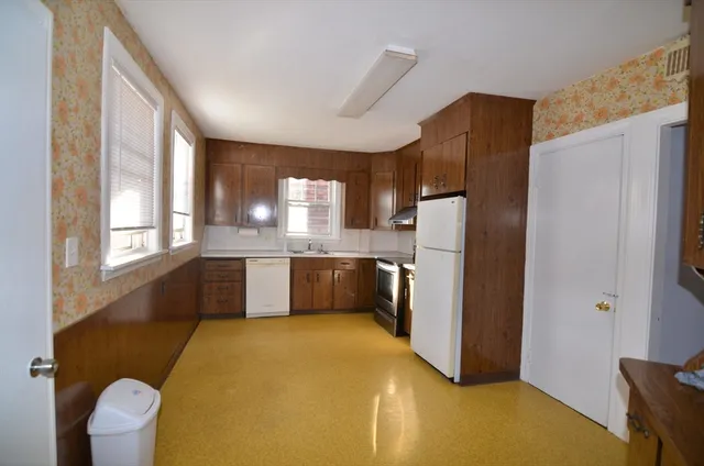 a kitchen with stainless steel appliances a refrigerator and a stove