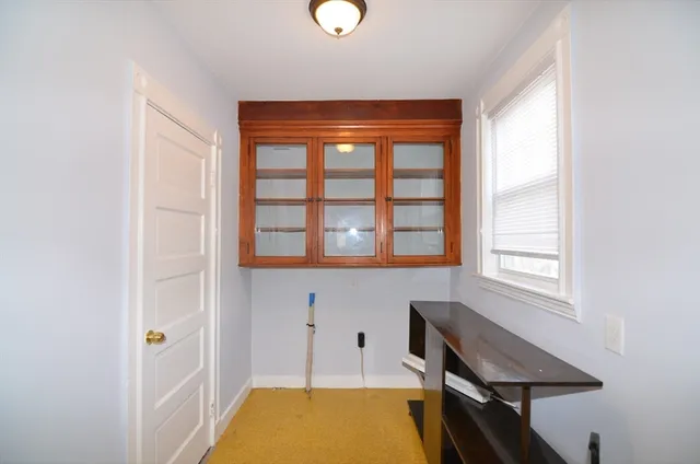 a view of a room with wooden floor and window