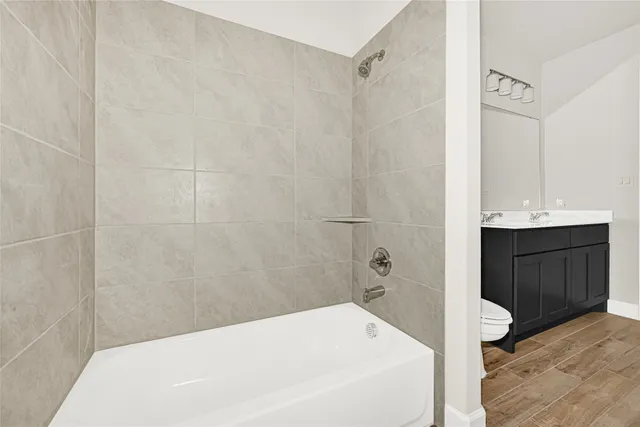 a bathroom with a bathtub and shower