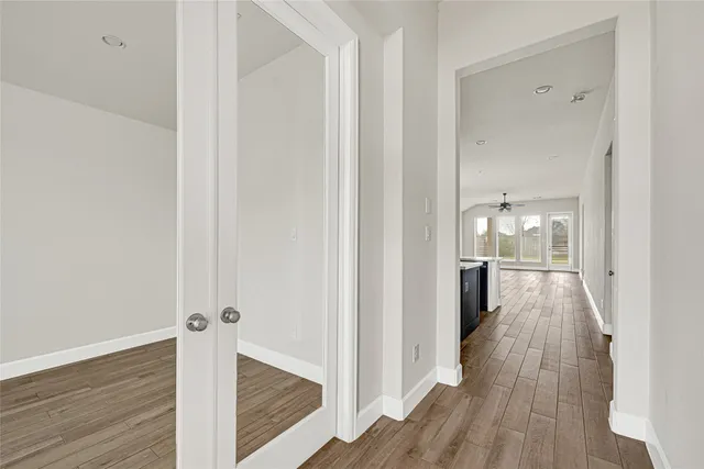 a view of a hallway with wooden floor