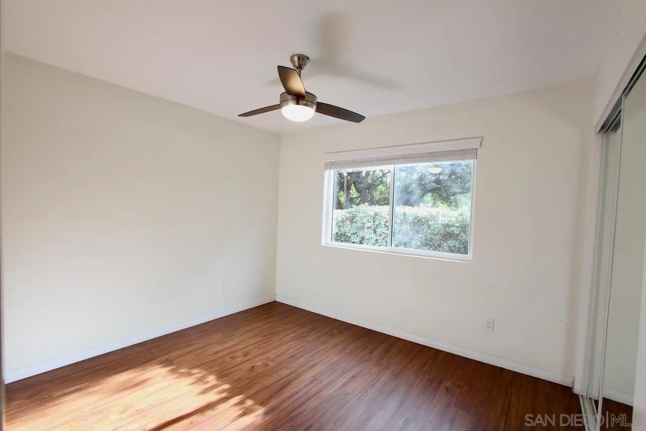 3021 Golden Oak Way Spring Valley, CA 91978 - Photo 11 of 20 a view of an empty room with wooden floor and a window