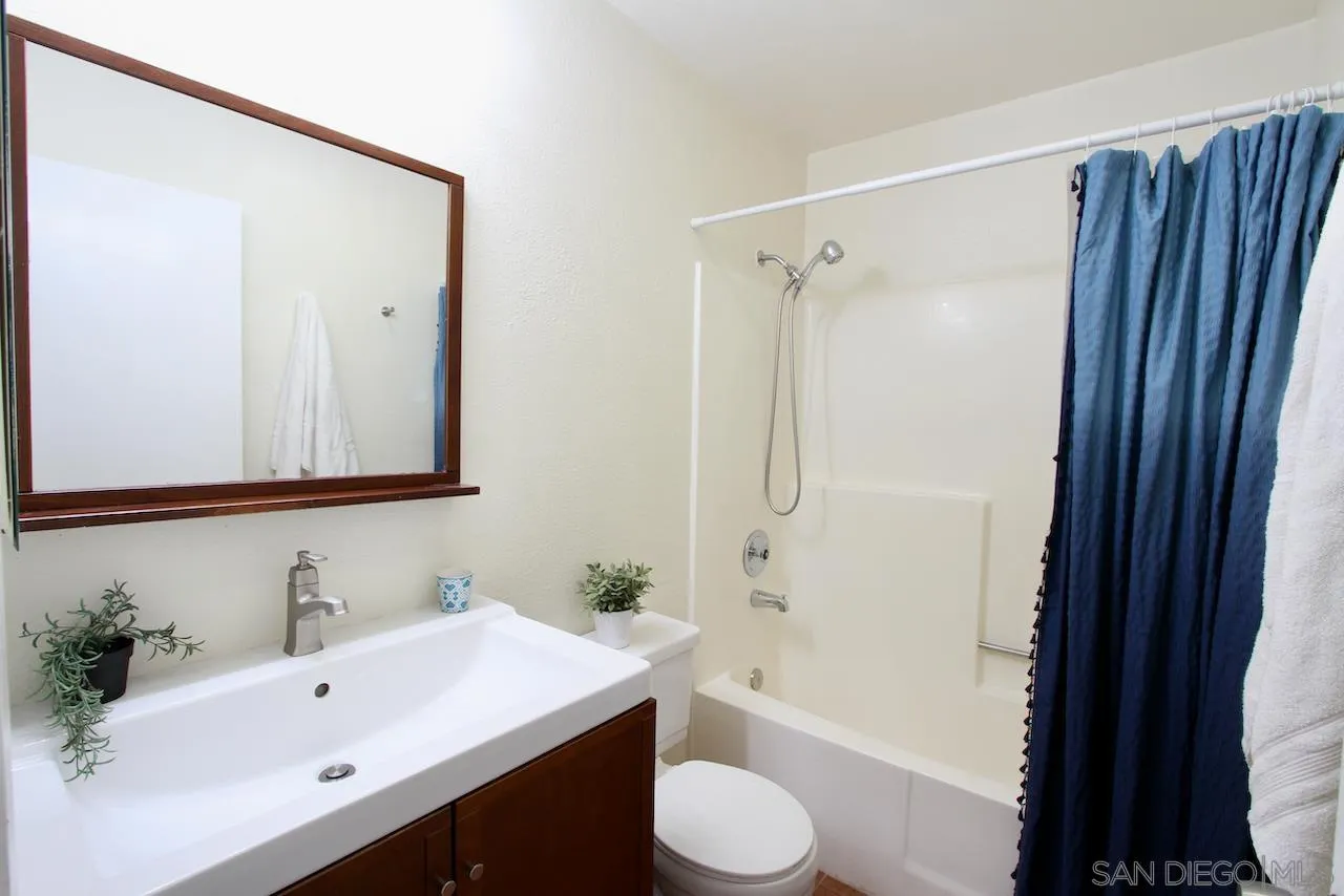 3021 Golden Oak Way Spring Valley, CA 91978 - Photo 12 of 20 a bathroom with a bathtub shower sink vanity and toilet
