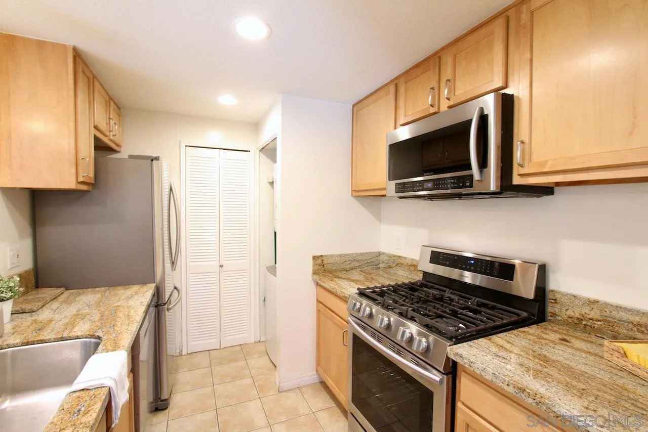 3021 Golden Oak Way Spring Valley, CA 91978 - Photo 4 of 20 a kitchen with stainless steel appliances granite countertop a stove and a microwave
