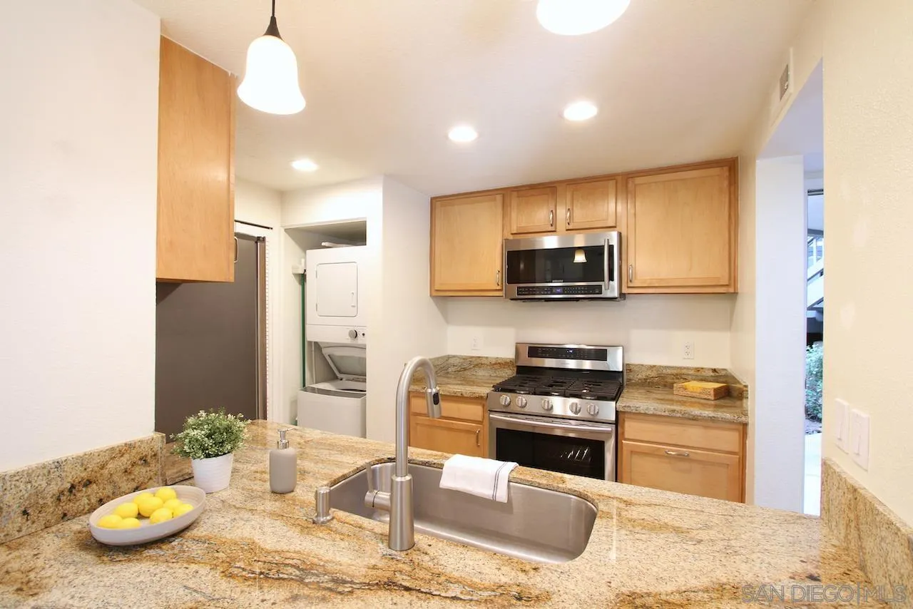 3021 Golden Oak Way Spring Valley, CA 91978 - Photo 5 of 20 a kitchen with granite countertop stainless steel appliances a stove a sink and microwave