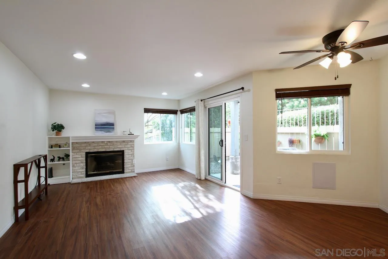 3021 Golden Oak Way Spring Valley, CA 91978 - Photo 6 of 20 a view of an empty room with wooden floor fireplace and a window