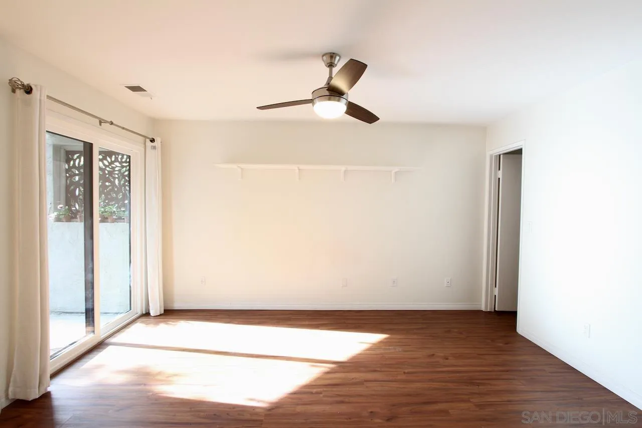 3021 Golden Oak Way Spring Valley, CA 91978 - Photo 7 of 20 a view of an empty room with wooden floor and a window