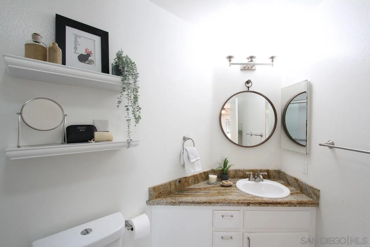 3021 Golden Oak Way Spring Valley, CA 91978 - Photo 8 of 20 a bathroom with a granite countertop sink and a mirror