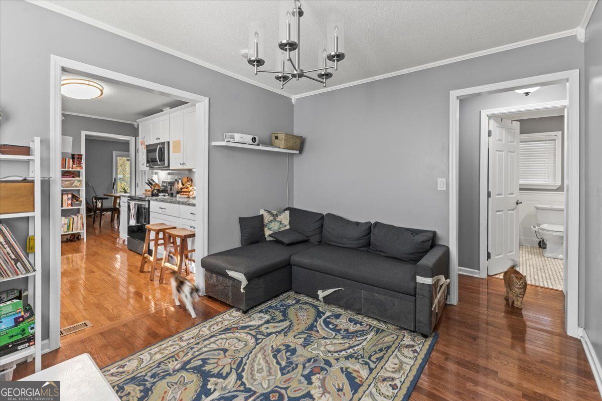 252 Langley Drive LaFayette, GA 30728 - Photo 24 of 29 a living room with furniture and a chandelier