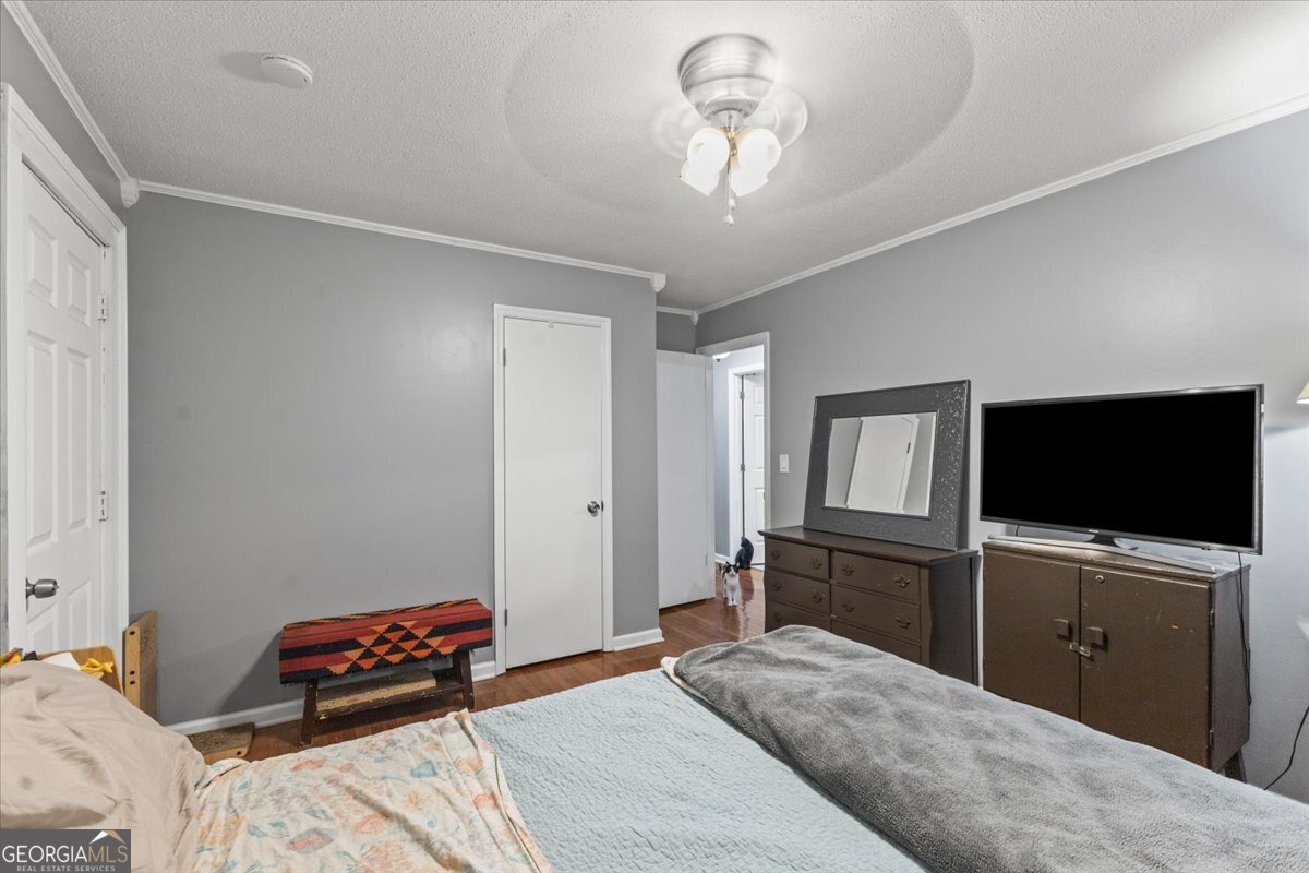 252 Langley Drive LaFayette, GA 30728 - Photo 29 of 29 a bedroom with a bed and a flat tv screen on wall