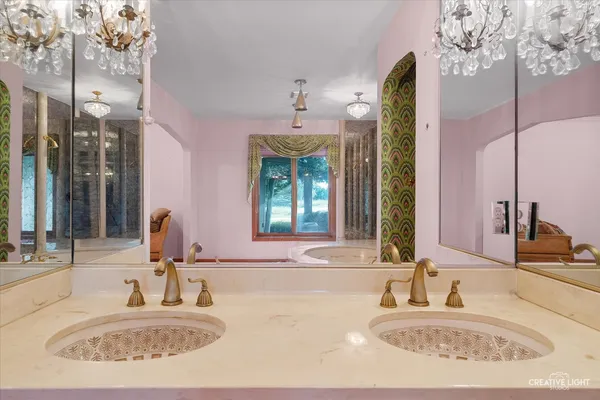 a bathroom with a granite countertop toilet sink and mirror