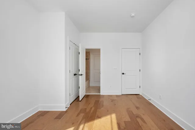 a view of a kitchen with a sink and dishwasher with wooden floor
