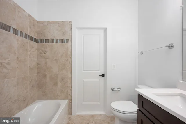 a kitchen with a stove a sink and a refrigerator