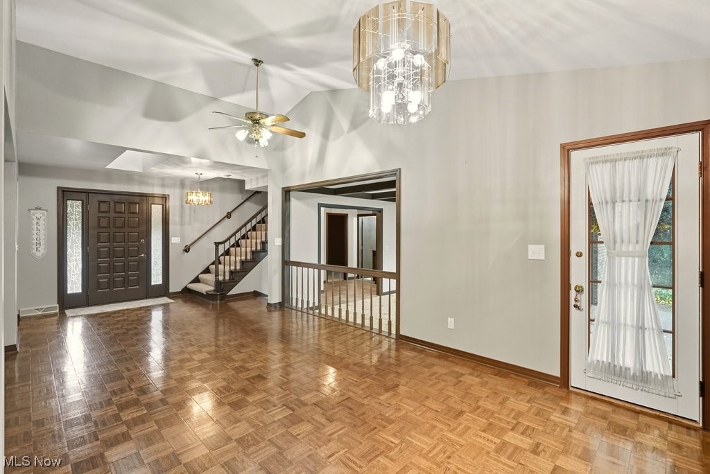 635 Inverness Road Akron, OH 44313 - Photo 11 of 36 Foyer entrance with a chandelier, stairs, lofted ceiling, and ceiling fan