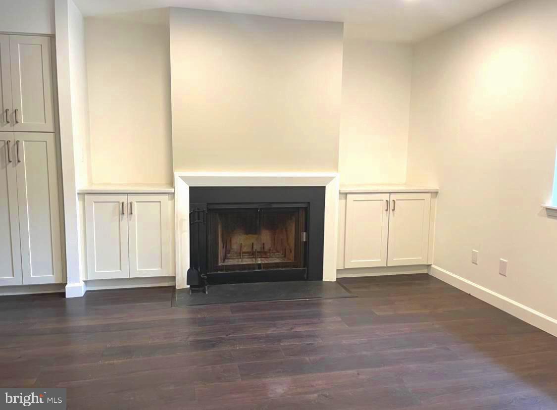 1106 Brinton Place Road, Unit 29 West Chester, PA 19380 - Photo 3 of 25 a view of empty room with wooden floor and fireplace