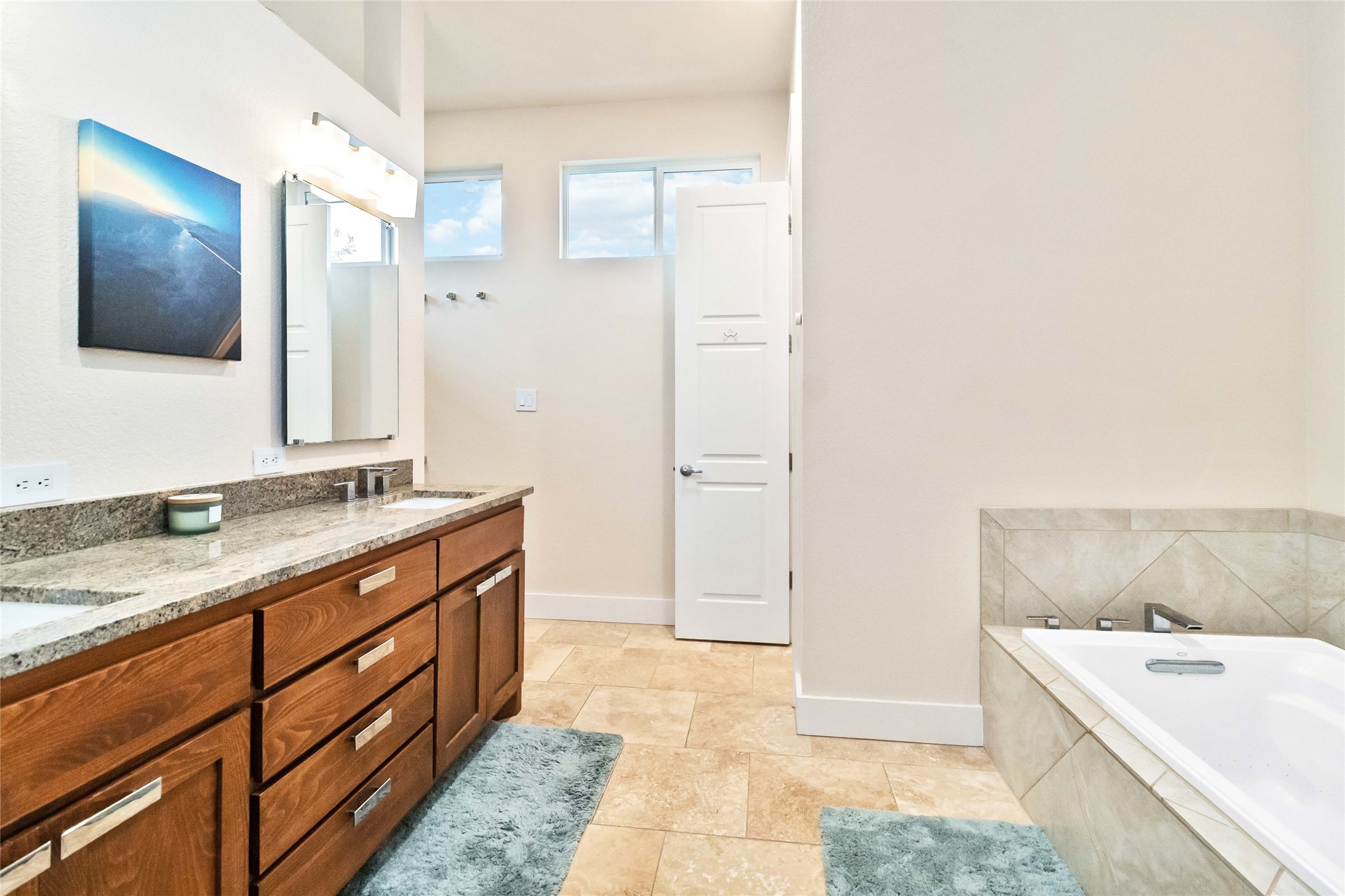 129 Powder Horn Road Bastrop, TX 78602 - Photo 22 of 27 Full bath with double vanity and a relaxing tiled tub