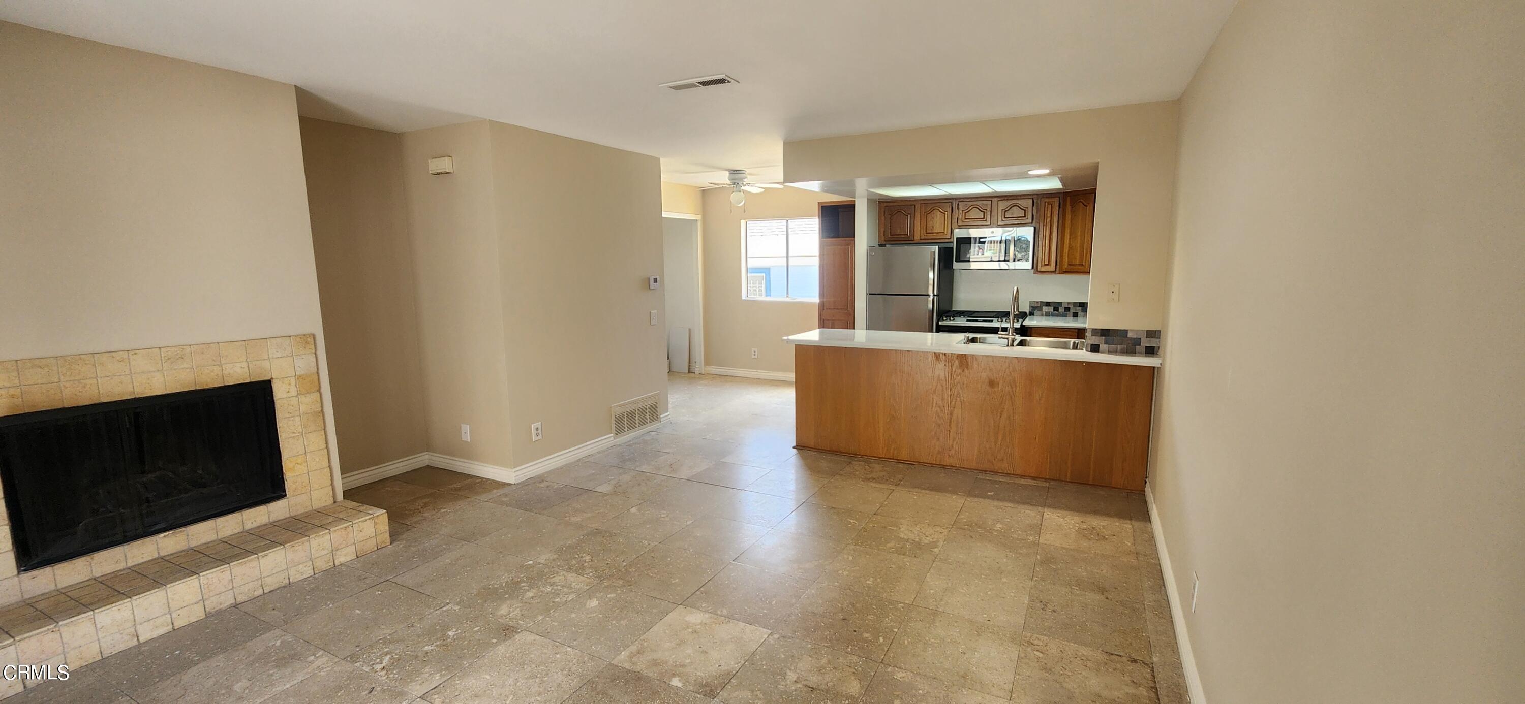 a view of a kitchen with a sink and a stove top oven
