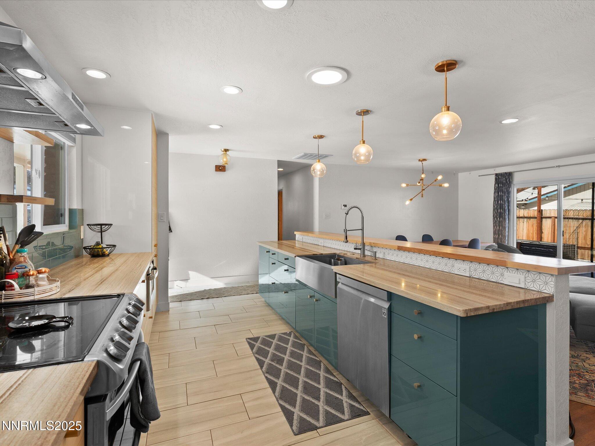 301 Hillcrest Drive Reno, NV 89509 - Photo 11 of 40 a large kitchen with a large counter top space appliances and cabinets