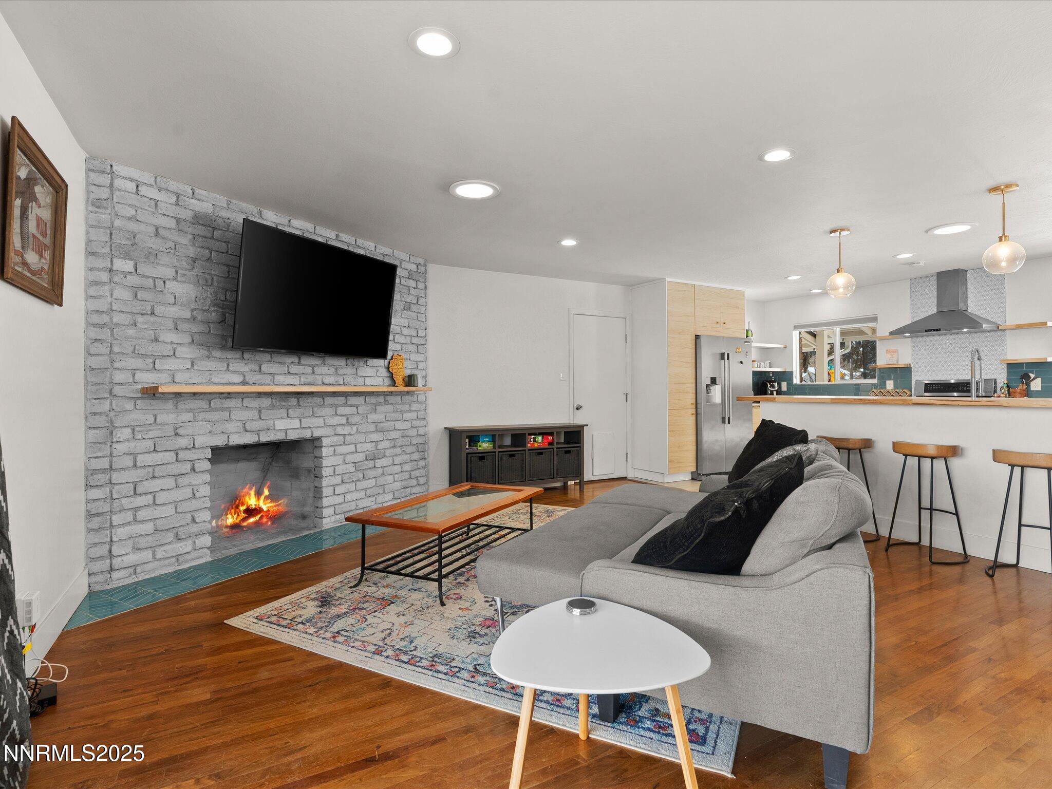 301 Hillcrest Drive Reno, NV 89509 - Photo 20 of 40 a living room with furniture a fireplace and a flat screen tv