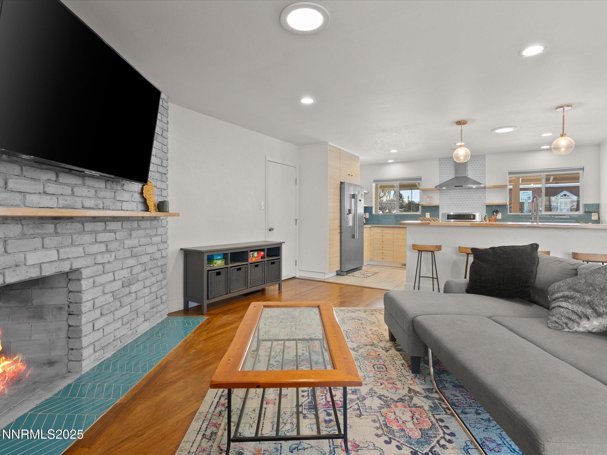 301 Hillcrest Drive Reno, NV 89509 - Photo 21 of 40 a living room with stainless steel appliances furniture or kitchen view and a fireplace