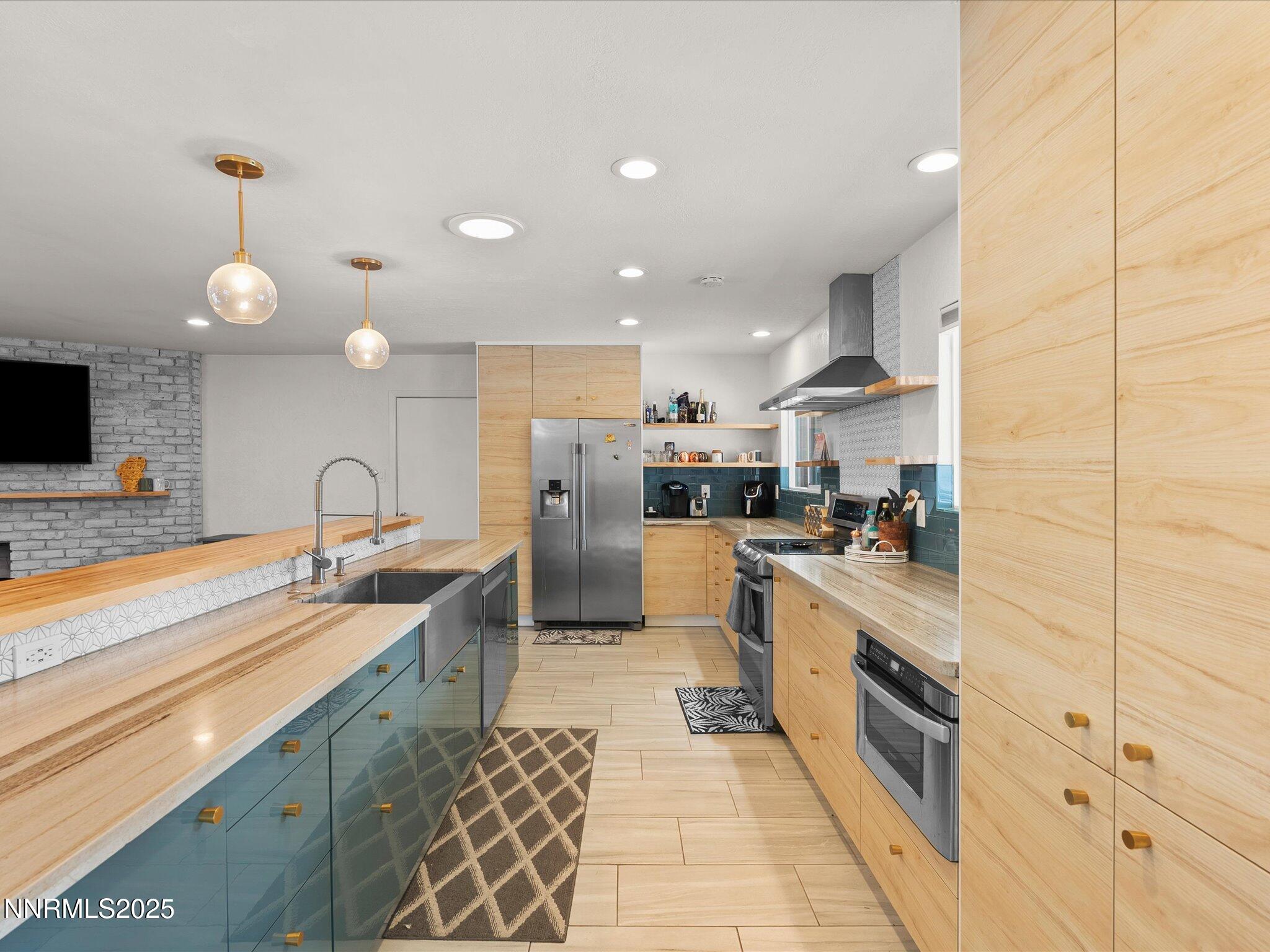 301 Hillcrest Drive Reno, NV 89509 - Photo 6 of 40 a kitchen with stainless steel appliances granite countertop a sink and cabinets