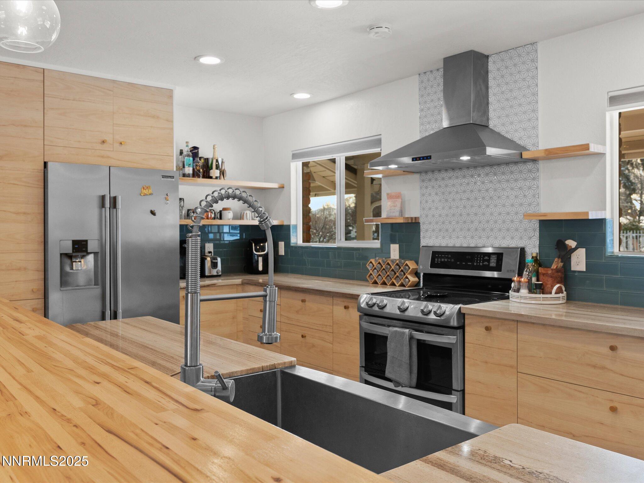 301 Hillcrest Drive Reno, NV 89509 - Photo 9 of 40 a kitchen with stainless steel appliances a stove and a refrigerator