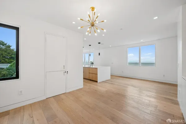 a view of a room with wooden floor and window