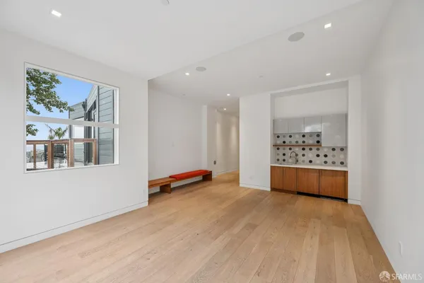 a view of a room with a large window and front door