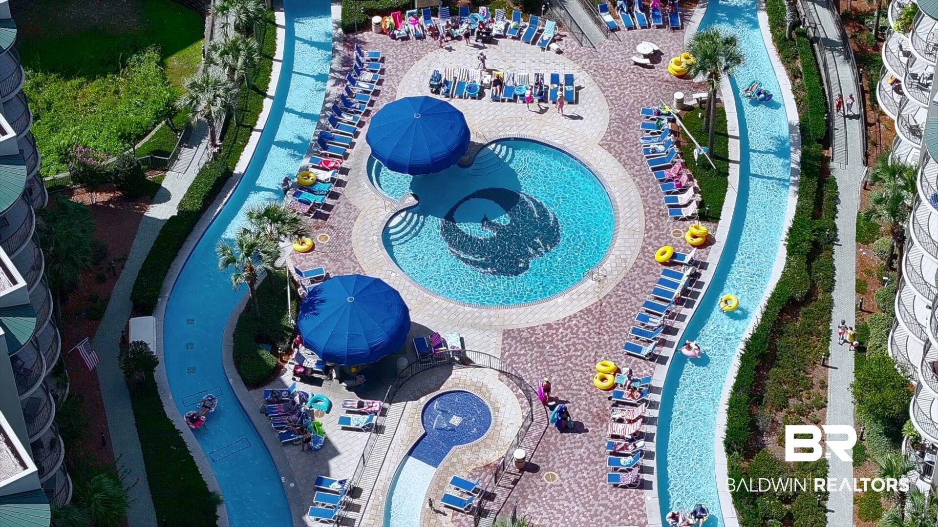 27580 Canal Road, Unit 1427 Orange Beach, AL 36561 - Photo 1 of 38 Drone / aerial view of a pool area and a community park