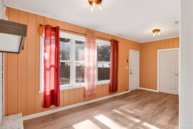 a view of a livingroom with wooden floor and a window