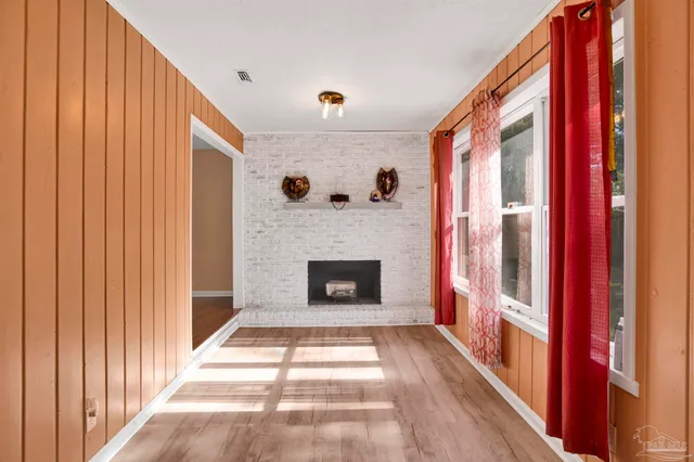 a view of a livingroom with a fireplace and window