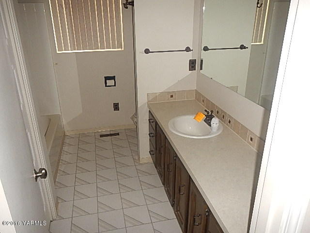 505 Bittner Road Yakima, WA 98901 - Photo 4 of 14 a bathroom with a sink a toilet and shower