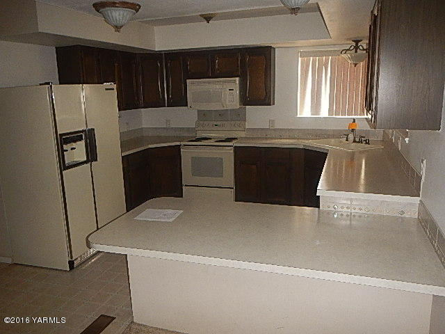 505 Bittner Road Yakima, WA 98901 - Photo 9 of 14 a kitchen with a refrigerator sink and stove